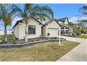 Charming single-Gathering home with a well-manicured lawn and a two-car garage on a sunny day at 14330 Fissore Blvd, Wimauma, FL 33598