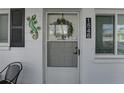 Close-up of the entrance, showcasing the door, house number, and decorative lizard wall art at 1546 Pleasant Rd # J1, Bradenton, FL 34207
