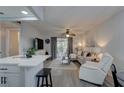 Bright living room with gray flooring, comfortable seating, and sliding glass doors leading to outdoor space at 1546 Pleasant Rd # J1, Bradenton, FL 34207