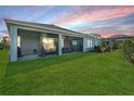 Expansive backyard featuring lush green grass and a covered lanai, perfect for outdoor living at 16407 Frehley Run, Land O Lakes, FL 34638