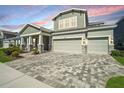 Charming home boasts three-car garage, decorative stone accents, and a beautifully paved driveway at 16407 Frehley Run, Land O Lakes, FL 34638