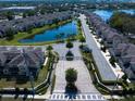 Aerial view of the gated community showcasing lush landscaping, a tranquil lake, and well-maintained streetscapes at 1986 Lake Ridge Blvd, Clearwater, FL 33763