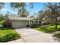 Well-maintained single-story home featuring a two-car garage and beautiful landscaping at 2251 Glenmoor N Rd, Clearwater, FL 33764