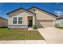 Charming single-Gathering home with a two-car garage and a well-manicured front yard at 35392 Eastbrook Ave, Zephyrhills, FL 33541