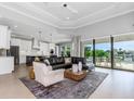 Open-concept living room with comfortable seating, stylish decor, and sliding glass doors at 4054 Rocky Shores Dr, Tampa, FL 33634