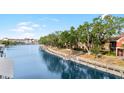 Scenic waterfront view with private docks and walkway lined by mature trees leading to residences at 5618 Baywater Dr # 5618, Tampa, FL 33615