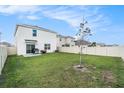 Large backyard featuring a grassy area, partial fence, and a patio for outdoor entertaining at 5640 Wandering Willow Dr, Wesley Chapel, FL 33545