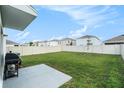Spacious fenced backyard with lush green grass, perfect for outdoor activities at 5640 Wandering Willow Dr, Wesley Chapel, FL 33545