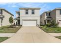 Attractive exterior view of a two-story home with an attached two-car garage at 5640 Wandering Willow Dr, Wesley Chapel, FL 33545