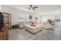 Spacious living room with tile flooring, recessed lighting, and a large sectional sofa at 5640 Wandering Willow Dr, Wesley Chapel, FL 33545