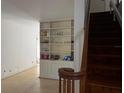 Open living room featuring built-in shelving and a staircase with wooden railing at 631 Hudson Ave, Tampa, FL 33606