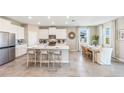 A modern open-concept kitchen featuring stainless steel appliances, a large island, and a dining area at 6700 Broad River Ave, Land O Lakes, FL 34638