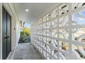 Covered walkway featuring geometric breeze blocks on a light colored home at 8704 Thornwood Ln, Tampa, FL 33615
