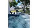 Relaxing backyard featuring a hot tub with comfortable seating, overlooking a scenic canal creating an ideal outdoor retreat at 8704 Thornwood Ln, Tampa, FL 33615