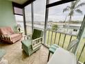 Bright sunroom featuring tile floors, large windows with water views, and comfortable seating at 1 Boca Ciega Point Blvd # 213, St Petersburg, FL 33708