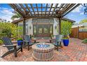 Outdoor patio with brick firepit, stylish pergola, seating, and elegant pavers at 101 30Th N Ave, St Petersburg, FL 33704