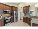 Well-equipped kitchen with stainless steel appliances, granite countertops, and wooden cabinetry at 10340 Lightner Bridge Dr, Tampa, FL 33626