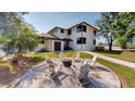 Charming backyard with a cozy fire pit surrounded by comfortable seating, perfect for outdoor entertaining at 10787 Oak Ne St, St Petersburg, FL 33716