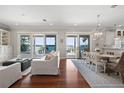 Open living room and dining area with hardwood floors and sliding glass doors to waterfront view at 1100 Cordova Ne Blvd, St Petersburg, FL 33704