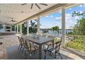 Covered outdoor dining area with ceiling fans, an outdoor fireplace, and beautiful water views at 1100 Cordova Ne Blvd, St Petersburg, FL 33704