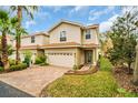 Lovely two-story townhome with terracotta roof, paved driveway, and well-maintained lawn at 1259 Ribolla Dr, Palm Harbor, FL 34683
