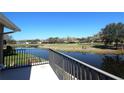 Scenic view of the golf course from the home's balcony with golf carts on green at 130 Water Oak Way, Oldsmar, FL 34677