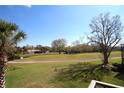 Picturesque view from balcony overlooking the golf course, ponds, and mature trees at 130 Water Oak Way, Oldsmar, FL 34677