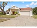 Inviting single-story home showcasing a two-car garage and manicured landscaping at 13542 Summerwood Ct, Hudson, FL 34667