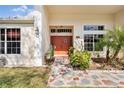 Close up of the front entrance with double doors, updated lighting and landscaped walkway at 13542 Summerwood Ct, Hudson, FL 34667