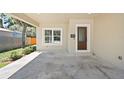 Covered entrance featuring front door with glass window, and concrete driveway at 23 N Edwards St, Plant City, FL 33563