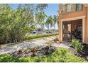 Waterfront residence with private patio, walkway, and lush vegetation leading to a private dock at 2733 Via Cipriani # 814A, Clearwater, FL 33764