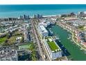 Wide angle view of a waterfront condo building with a green rooftop, positioned near the beach and a marina at 400 150Th Ave # 206, Madeira Beach, FL 33708