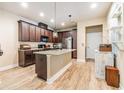 Beautiful kitchen featuring an island with a granite countertop and modern appliances at 450 Harbor Springs Dr, Palm Harbor, FL 34683