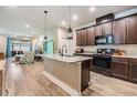 Stylish kitchen featuring an island with a granite countertop and modern appliances at 450 Harbor Springs Dr, Palm Harbor, FL 34683