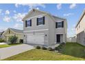 Two-story home with a wide driveway, complemented by green grass and trimmed landscaping at 4727 Lindever Ln, Palmetto, FL 34221