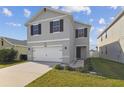 Two-story home featuring a modern gray exterior, complete with black shutters and green lawn at 4727 Lindever Ln, Palmetto, FL 34221