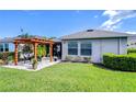 A spacious backyard features a pergola over a patio area, perfect for outdoor entertaining and relaxation at 6113 Plover Meadow St, Lithia, FL 33547