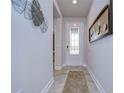 Bright foyer with tile flooring, decorative accents, and a glass-paneled front door offers a welcoming entrance at 6113 Plover Meadow St, Lithia, FL 33547