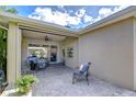 Covered patio with brick pavers, ceiling fan, and comfortable seating provides a relaxing outdoor living space at 6113 Plover Meadow St, Lithia, FL 33547