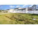 Charming two-story home with manicured lawn and white fence, set against a beautiful blue sky at 628 47Th W St, Palmetto, FL 34221