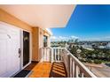 Enjoy city views from this condo balcony with tile floors and a white railing at 6500 Sunset Way # 501, St Pete Beach, FL 33706