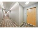 Hallway with patterned carpet leading to unit entrance at 777 N Ashley Dr # 915, Tampa, FL 33602