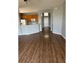 Open-concept living room featuring updated flooring and a view of the kitchen at 8480 Southern Charm Cir, Brooksville, FL 34613