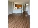 Open-concept living room featuring updated flooring and a view of the kitchen at 8480 Southern Charm Cir, Brooksville, FL 34613