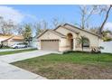 Inviting single-story home with a manicured lawn, a two-car garage, and warm curb appeal at 918 W Knollwood St, Tampa, FL 33604