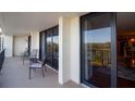 Spacious balcony with seating offers serene views of the surrounding landscape and partial water view at 100 Oakmont Ln # 605, Belleair, FL 33756