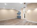 Spacious living room with a vaulted ceiling, a ceiling fan, and wood-look flooring at 104 Anclote Rd # 104, Tarpon Springs, FL 34689