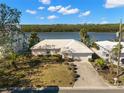 Aerial view of the home, showcasing proximity to water, large lot, and lush landscaping at 10427 Spoonbill W Rd, Bradenton, FL 34209