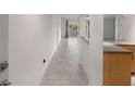 View of the home's hallway with diagonally-laid tile floor leading to the outdoor balcony at 1200 N Shore Ne Dr # 102, St Petersburg, FL 33701