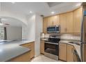 Bright, modern kitchen featuring stainless steel appliances, light wood cabinets and tile backsplash at 1200 N Shore Ne Dr # 102, St Petersburg, FL 33701